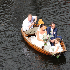 A wedding party on a rowing boat on the river