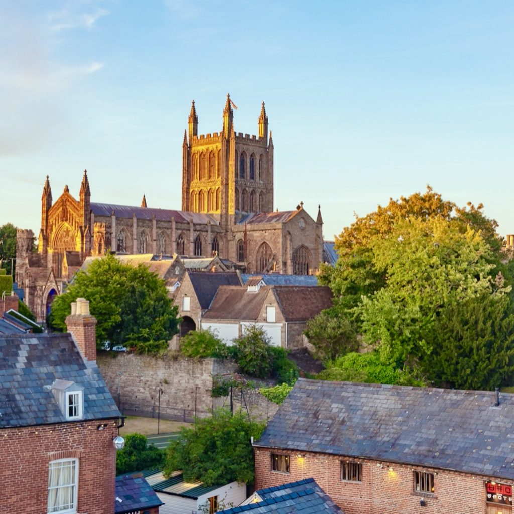 A courtyard in summer with hereford cathedral the distance