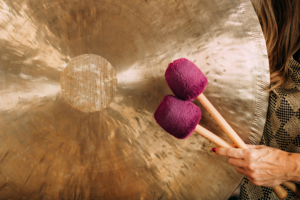 two pink gong mallets and a golden gong